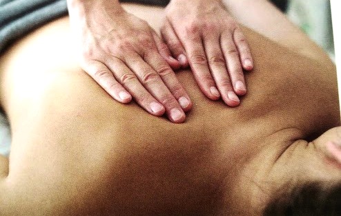 lady with severe back pain having sports massage in our cardiff clinic